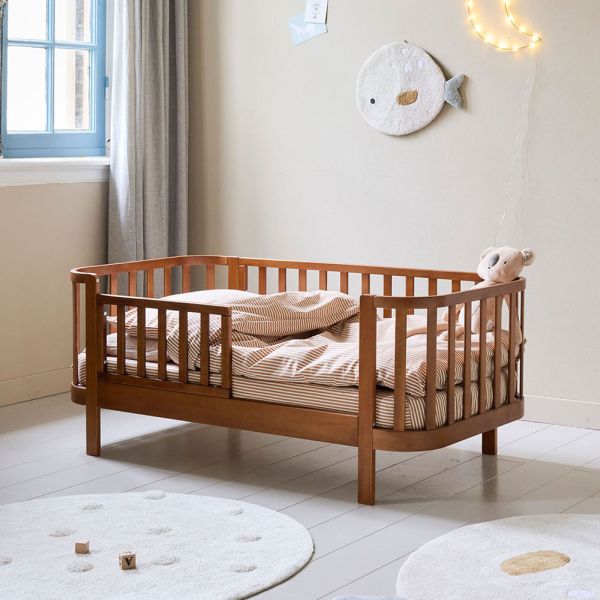 Toddler bed made from wood in walnut cocoon from Petite Amélie