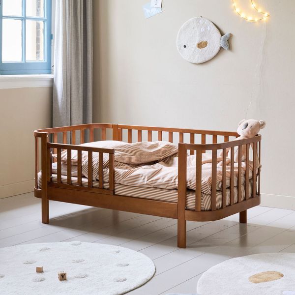 Toddler bed made from wood in walnut cocoon from Petite Amélie